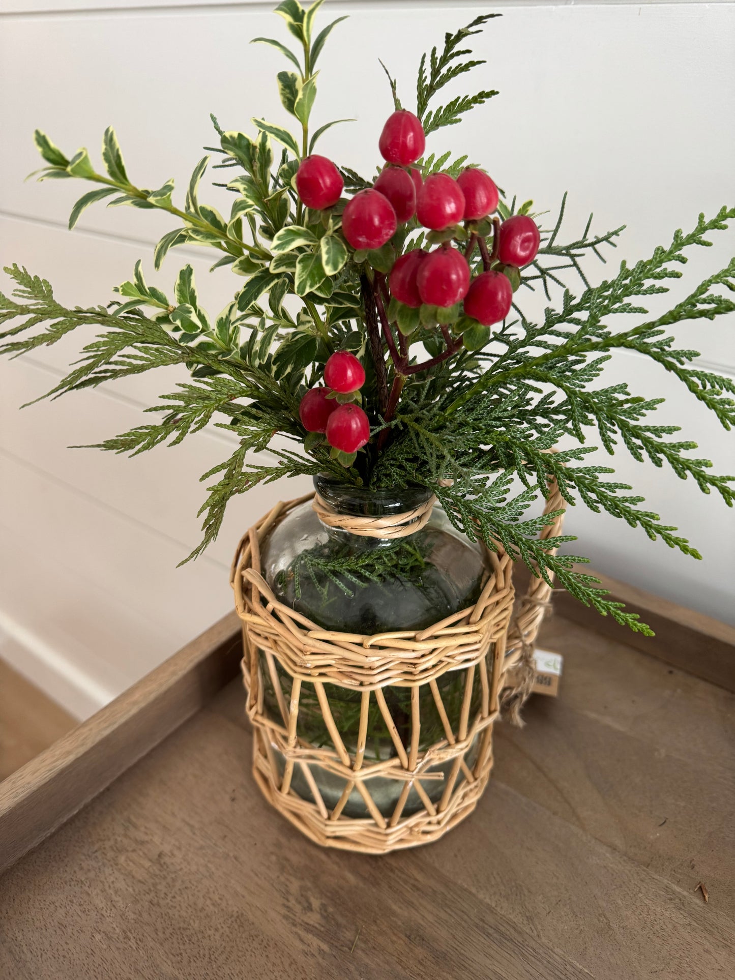 Greenery with red Berries in Glass Vase with Rattan