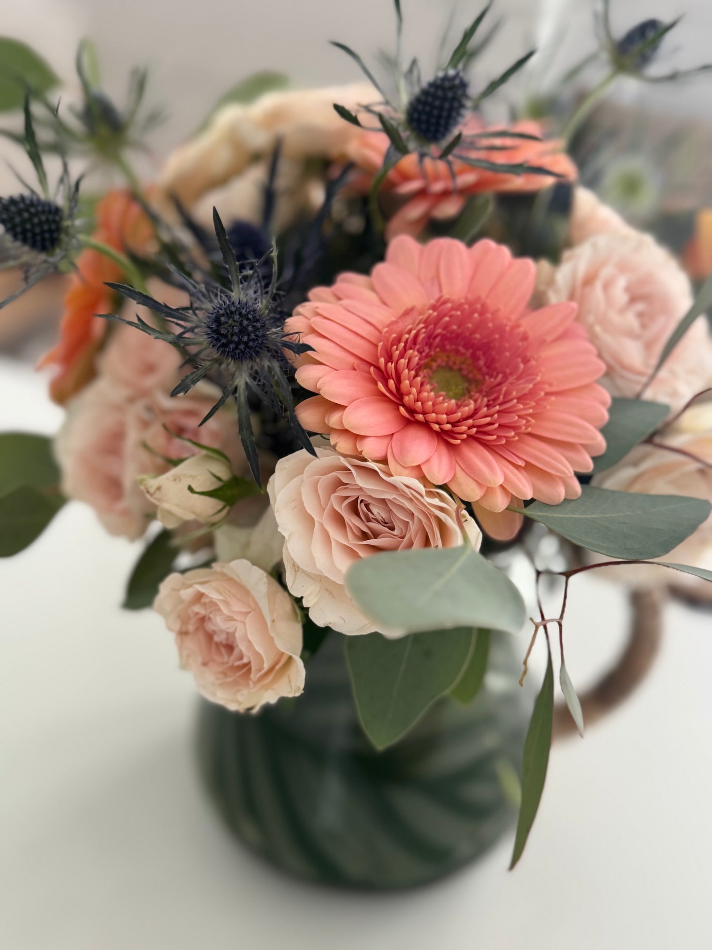 Floral Arrangement in Glass Watering Jar