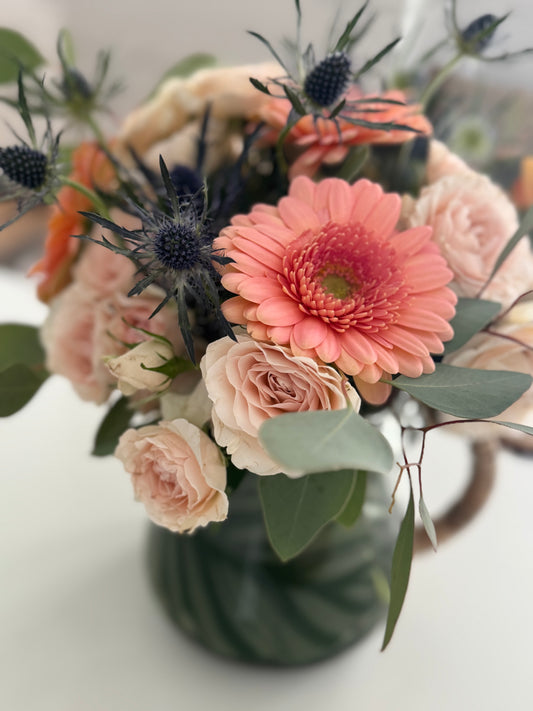 Floral Arrangement in Glass Watering Jar